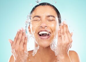 Shot of Young Woman Washing Face